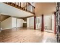 Spacious living room featuring hardwood floors, a fireplace, and access to the outdoors at 2694 S Xanadu Way # D, Aurora, CO 80014