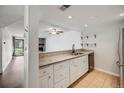 Modern kitchen features granite countertops, stainless steel appliances and an open view of the living room at 401 S Kalispell Way # 206, Aurora, CO 80017