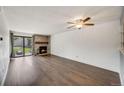 Bright living room features hardwood floors, a stone fireplace and large windows offering natural light at 401 S Kalispell Way # 206, Aurora, CO 80017