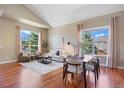 Bright living room with large windows and hardwood floors, offering ample seating and natural light at 7472 Iridium Way, Castle Rock, CO 80108