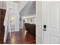 Inviting foyer with hardwood floors, staircase, high ceilings, and a view into the dining area at 8452 Everett Way # C, Arvada, CO 80005