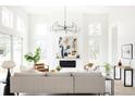 Bright living room with high ceilings, fireplace, and an abundance of natural light from large windows at 3530 Fenton St, Wheat Ridge, CO 80212