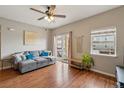 Cozy living room with hardwood floors, slider door, and comfortable gray sofa at 1771 W 53Rd Pl # 2, Denver, CO 80221