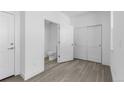 Bright bedroom with wood-look floors, closet and a convenient ensuite half bathroom at 14261 Currant St, Broomfield, CO 80020