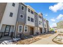 Contemporary townhome exteriors featuring a mix of siding and brickwork with well-maintained landscaping at 14261 Currant St, Broomfield, CO 80020