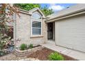 Inviting entryway with brick accents and professional landscaping; a warm welcome to a beautiful home at 17692 E Brunswick Pl, Aurora, CO 80013