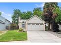 Charming home with a well-manicured front lawn and an attached two-car garage in a quiet neighborhood at 17692 E Brunswick Pl, Aurora, CO 80013