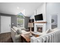 Cozy living room features a fireplace, large windows and a modern design that is perfect for relaxing at 17692 E Brunswick Pl, Aurora, CO 80013