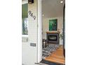 Inviting entryway featuring a fireplace, hardwood floors, and contemporary decor elements at 949 Pontiac St, Denver, CO 80220