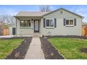 A charming home with a neatly landscaped front yard and a well-maintained exterior at 949 Pontiac St, Denver, CO 80220