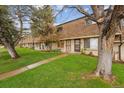 View of a townhouse complex with mature trees and green lawns at 12927 W 20Th Ave, Golden, CO 80401
