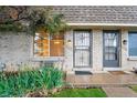 Close-up of a townhouse entrance with brick facade and decorative security door at 12927 W 20Th Ave, Golden, CO 80401