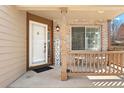 Inviting front porch with brick accents and a 'Welcome' sign for a warm greeting at 12710 W 84Th Cir, Arvada, CO 80005