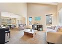 Bright living room featuring high ceilings, neutral tones, and plenty of natural light at 12710 W 84Th Cir, Arvada, CO 80005