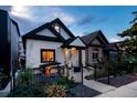 Updated craftsman home with a black fence and landscaping at 3443 Lawrence St, Denver, CO 80205