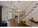 Grand foyer with hardwood flooring, a curved staircase, and an open layout at 7056 S Owens St, Littleton, CO 80127