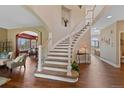 Open staircase with a view of the living room and dining room at 7056 S Owens St, Littleton, CO 80127