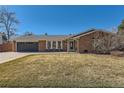 Charming brick home featuring a well-manicured front yard and an attached two-car garage at 6342 W Fremont Dr, Littleton, CO 80128