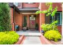 Inviting front porch with elegant wood door, stylish decor, and ample space for seating at 2153 S Columbine St, Denver, CO 80210