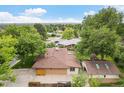 This aerial view captures the expansive roof of the home, accented by verdant trees and neighborhood charm at 1475 S Urban Way, Lakewood, CO 80228