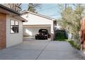 Spacious detached garage showcasing a vintage car, with extra storage space and access from the driveway at 1475 S Urban Way, Lakewood, CO 80228
