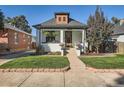 Charming bungalow featuring a well-manicured front yard and inviting front porch at 1749 S Lincoln St, Denver, CO 80210