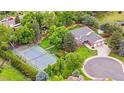 Aerial view of the home's exterior, manicured grounds, and a nearby tennis court at 7330 Routt St, Arvada, CO 80005