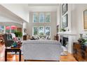 Bright living room boasts high ceilings, large windows, fireplace, and hardwood floors at 7330 Routt St, Arvada, CO 80005