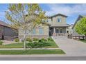 Charming two-story home featuring stone accents, an attached garage, and a cozy front porch at 525 Grenville Cir, Erie, CO 80516