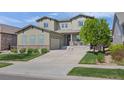 Charming two-story home with an attached garage, manicured lawn, and a welcoming front porch at 525 Grenville Cir, Erie, CO 80516