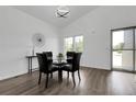 Contemporary dining area with a glass table, black chairs, and modern decor at 8935 Sleepy Grass Ct, Parker, CO 80134