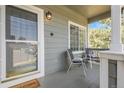 Cozy front porch with seating, plants, and a welcoming entrance at 8935 Sleepy Grass Ct, Parker, CO 80134