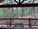 Relax on the deck, offering peaceful views of the surrounding pine forest at 9705 Canon Dr, Sedalia, CO 80135