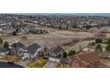 Expansive aerial view capturing the property's location within a community bordered by open fields at 22630 E Ida Cir, Aurora, CO 80015