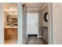Inviting hallway with gray walls that leads to a bathroom, with a tiled floor and an entryway at 1850 Folsom St # 402, Boulder, CO 80302