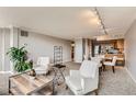 A comfortable living room featuring neutral decor and modern furnishings adjacent to dining area and kitchen at 1850 Folsom St # 402, Boulder, CO 80302