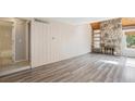 Spacious living area featuring a stone fireplace and new hardwood floors at 2453 S Xanadu Way # C, Aurora, CO 80014