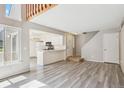 Open-concept living area featuring new flooring and an abundance of natural light at 2453 S Xanadu Way # C, Aurora, CO 80014