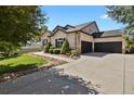 This lovely home features a three car garage and well manicured landscaping with mature trees at 5421 Potentilla Ct, Parker, CO 80134