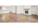 Spacious living room with a fireplace and wood-look flooring at 9343 Biscay St, Commerce City, CO 80022