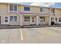 A sunny day view of the exterior of Kings Mill, with parking spaces labeled for each unit at 8915 Field St # 118, Broomfield, CO 80021