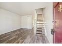 Inviting living room boasts modern flooring and staircase leading to upper level at 8915 Field St # 118, Broomfield, CO 80021