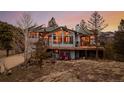 Beautiful two-story home featuring a spacious deck perfect for enjoying the mountain views at 37 High View Ln, Boulder, CO 80302