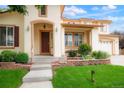 Charming home exterior featuring a well-manicured lawn, front porch and a warm, inviting entrance at 16650 E 107Th Ct, Commerce City, CO 80022