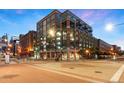 Corner building with brick and glass facade, street lights, and visible crosswalks under a clear blue sky at 1890 Wynkoop St # 806, Denver, CO 80202