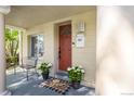 Cozy front porch featuring a decorative door, charming plants, and a welcoming atmosphere at 3929 Shoshone St, Denver, CO 80211
