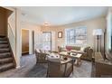 Bright living room featuring a cozy sofa and large windows at 164 Bristlecone St, Brighton, CO 80601