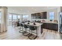 Bright modern kitchen with oversized island, stainless appliances, and stylish seating at 12762 Bend Ct, Firestone, CO 80504