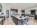 Spacious kitchen with large island, stainless steel appliances, pantry and adjacent living space at 12762 Bend Ct, Firestone, CO 80504