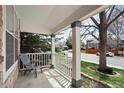 Inviting covered front porch with white railings and stone accents, a tranquil space to sit and enjoy the neighborhood views at 708 S Carlton St, Castle Rock, CO 80104